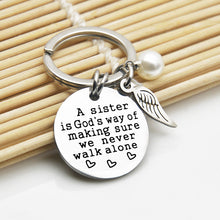 Load image into Gallery viewer, A Sister is God&#39;s Way of Making Sure We Never Walk Alone Keychain